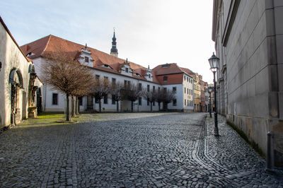 Footpath amidst buildings in town