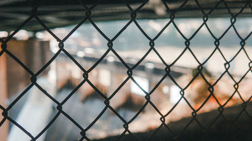 Close-up of chainlink fence against sky