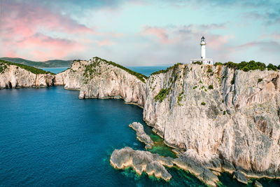 Scenic view of lighthouse by sea against sky