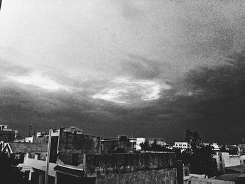 Buildings against cloudy sky