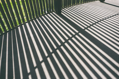 High angle view of shadow on railing
