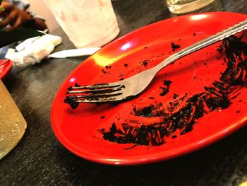 High angle view of red plate on table
