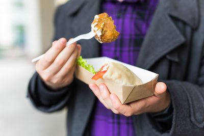 Midsection of woman holding ice cream