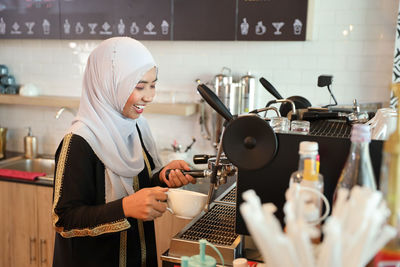 Woman holding coffee cup