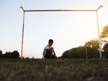 Little child goalkeeper in soccer field