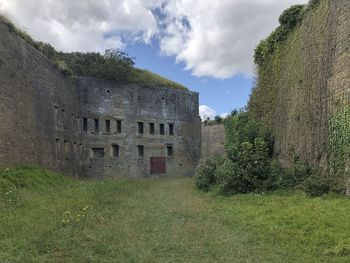 Old building on field against sky