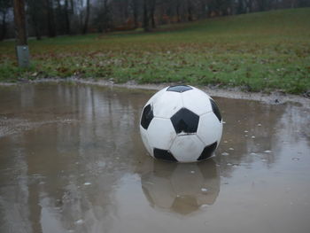 Close-up of soccer ball on footpath