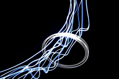 Close-up of light trails over black background