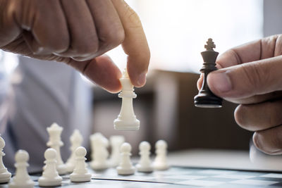 Cropped image of hands holding chess pieces