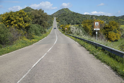 Country road against sky