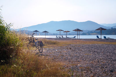 People riding bicycle on land against sky