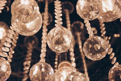Close-up of illuminated lanterns hanging in glass