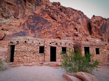 Old ruins by mountains against clear sky