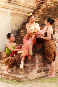 Young female models wearing traditional clothing at brick steps