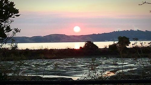 Scenic view of lake at sunset