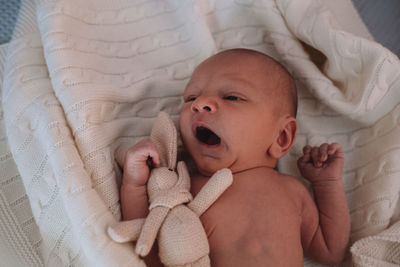 Portrait of cute baby boy sleeping on bed