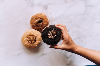 Cropped hand of person holding cookies