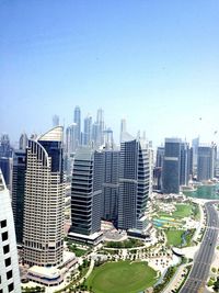 Skyscrapers in city against blue sky