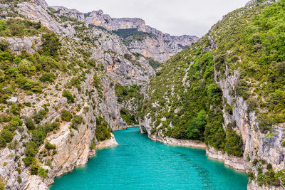 High angle view of sea and mountains against sky