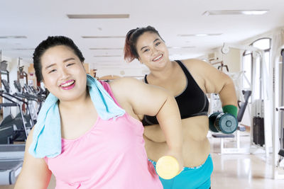 Female friends exercising in gym