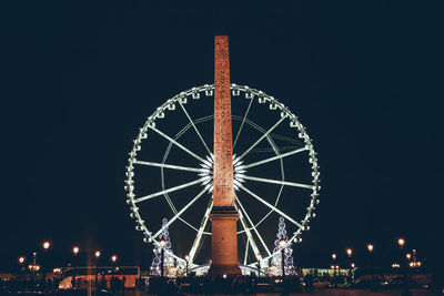 Low angle view of ferris wheel against sky at night