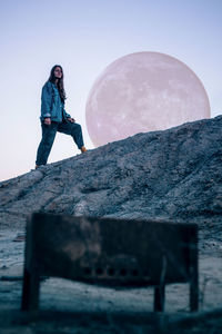 Low angle view of man standing against sky