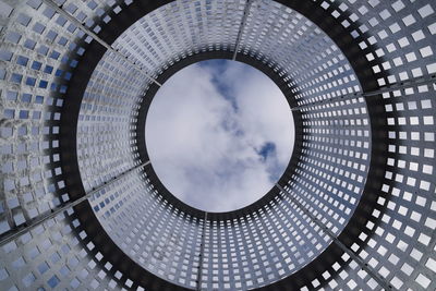 Low angle view of skylight in building against sky