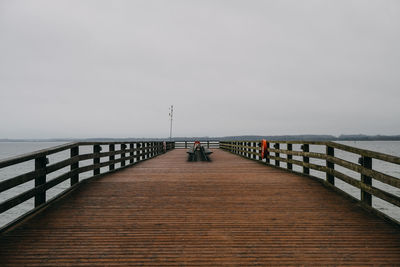 Pier over sea against clear sky