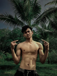 Young man standing on palm tree