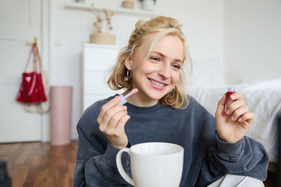 Portrait of young woman using mobile phone