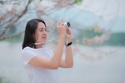 Young woman photographing