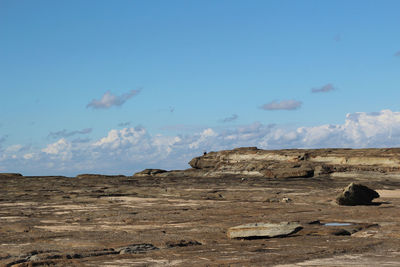 Rock formations in desert against blue sky