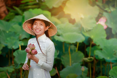 Portrait of woman wearing hat standing outdoors