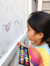 Close-up of girl playing with abacus at home