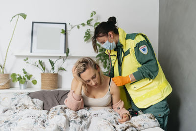 Doctor examining patient at home