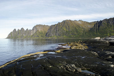 Scenic view of sea and mountains against sky