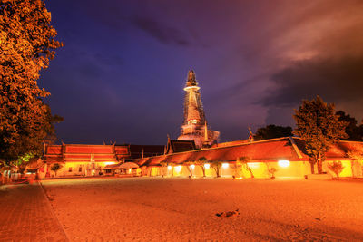 Illuminated building against sky at dusk