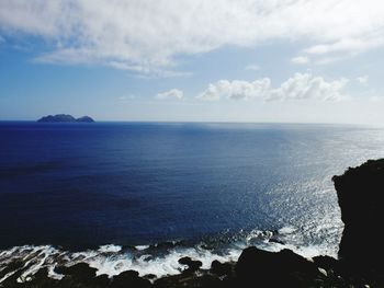 Scenic view of sea against cloudy sky