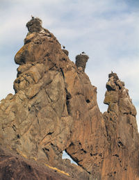 Low angle view of rock formations against sky