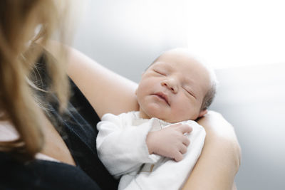 Mother with newborn baby at home