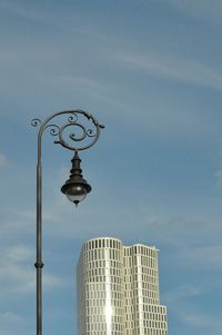 Low angle view of street light against building