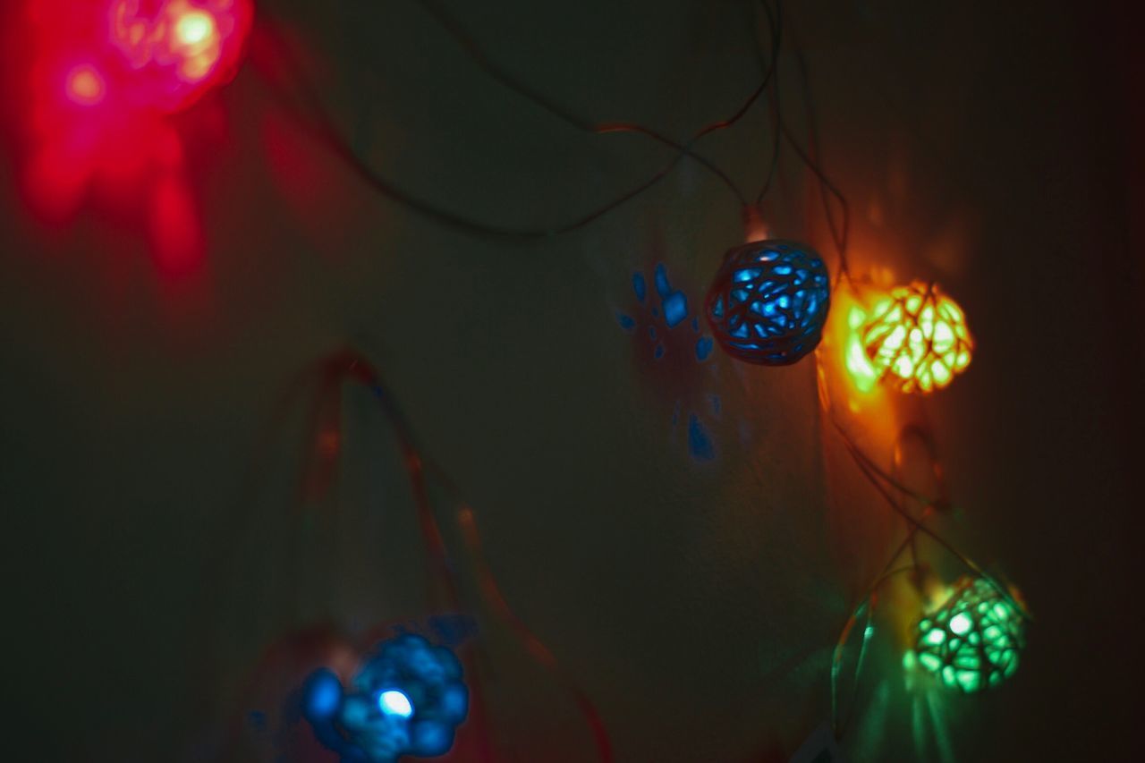 CLOSE-UP OF ILLUMINATED LIGHTING EQUIPMENT HANGING ON CHRISTMAS LIGHTS