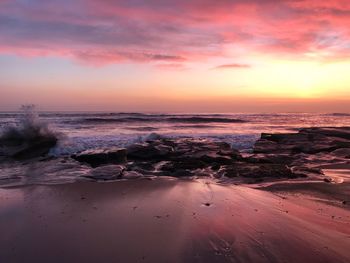 Scenic view of beach against sky during sunset