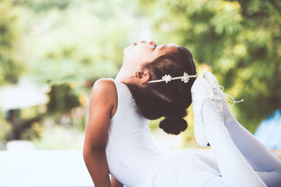 Cute ballerina dancing outdoors