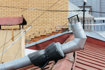 Close up photo ventilation pipe from stainless steel on red rooftop. the ventilation system