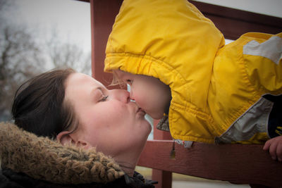 Mother and son kissing in vehicle