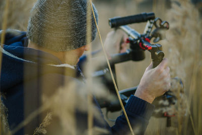 Photographer adjusting shoulder mount camera in field