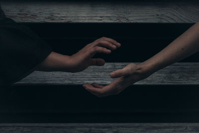 Midsection of woman hands on sea shore