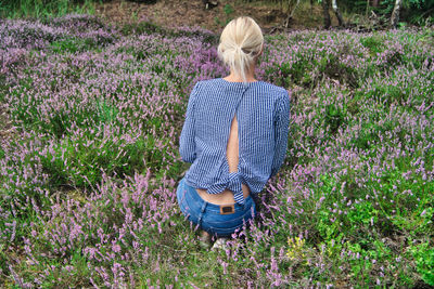 Rear view of woman standing on field