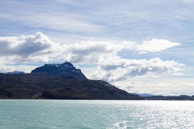 Scenic view of sea and mountains against sky